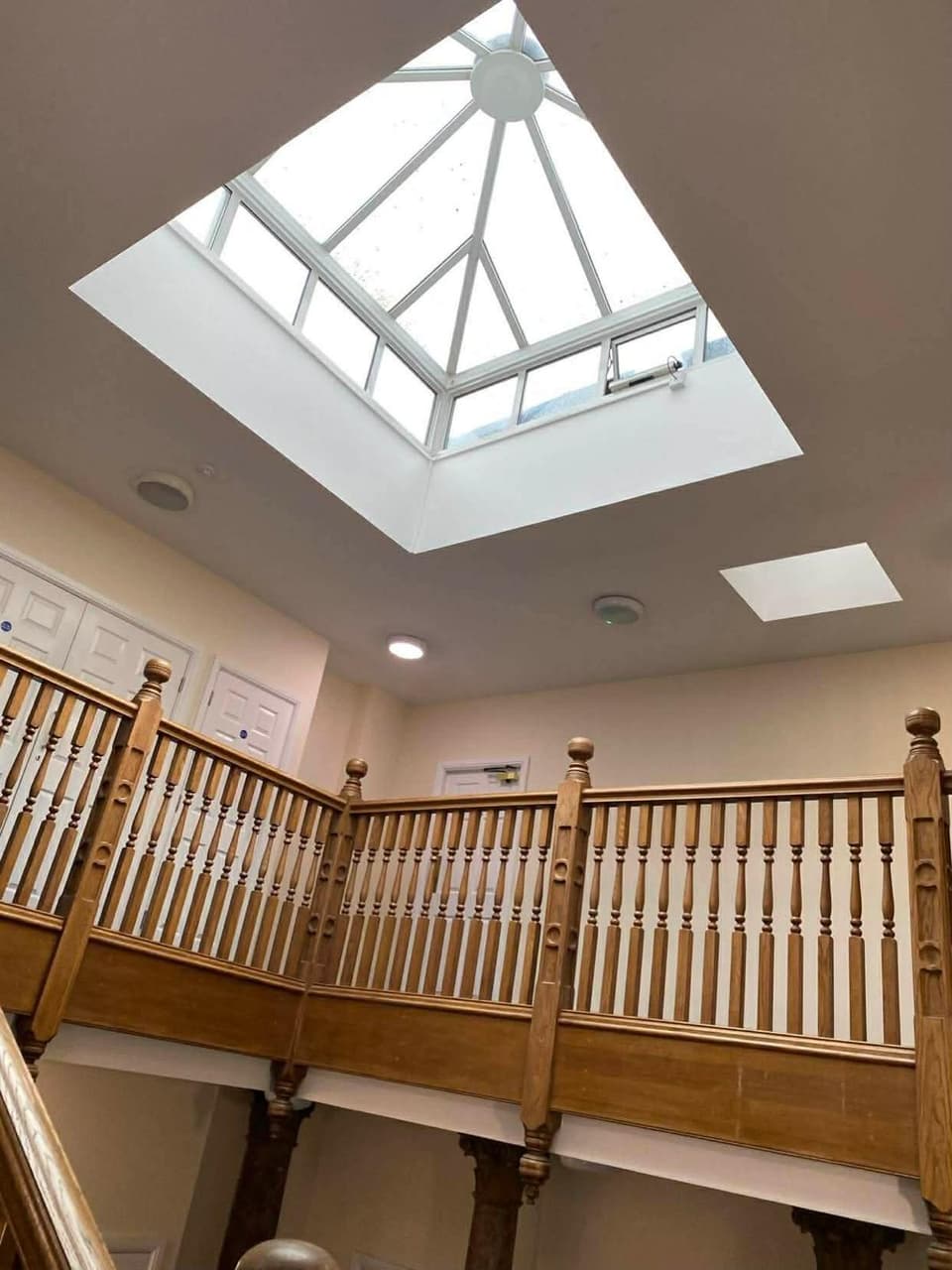 Glazed roof lantern above an oak galleried landing in an Epsom period conversion
