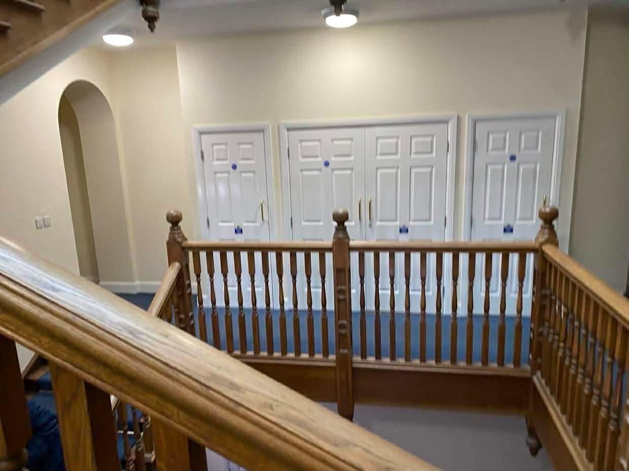 Oak galleried landing and flat doors in the first Epsom block