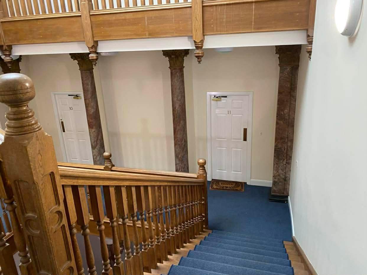 Marble columns and numbered flat doors seen from the Epsom galleried landing