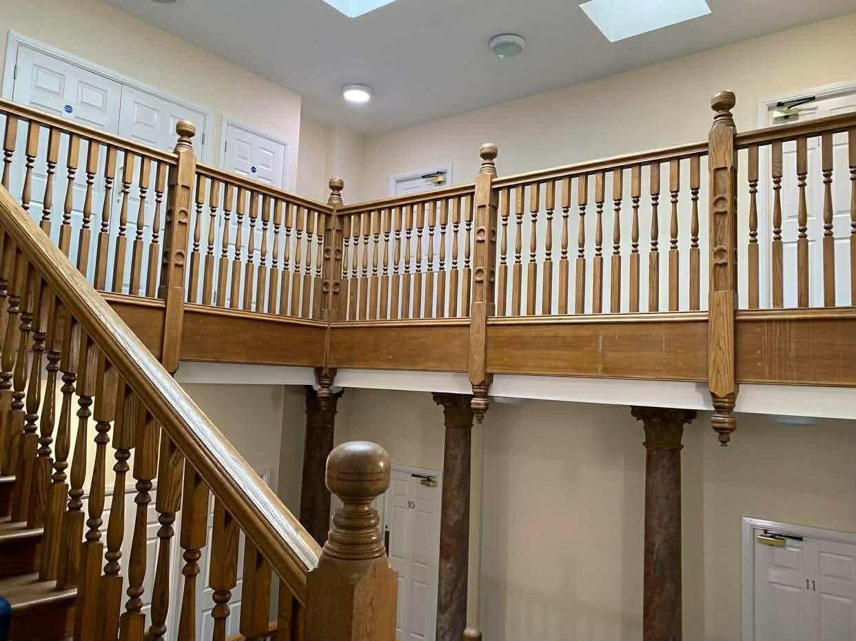 Full view of the oak gallery running around the open stairwell in the first Epsom block