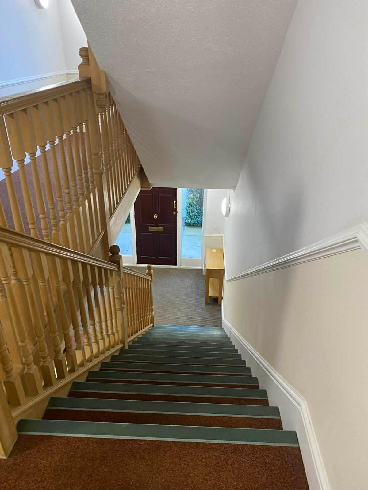 View down the Sutton communal stairwell towards the entrance door and ground floor lobby