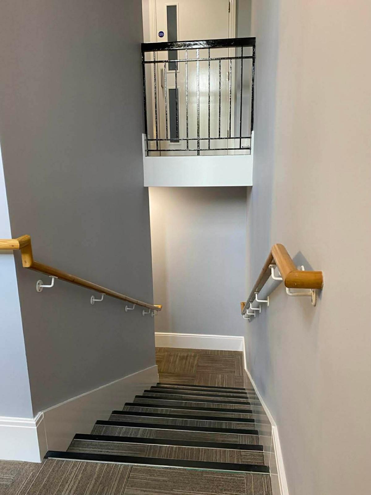 Half landing with a wrought iron balustrade in the second Wallington block