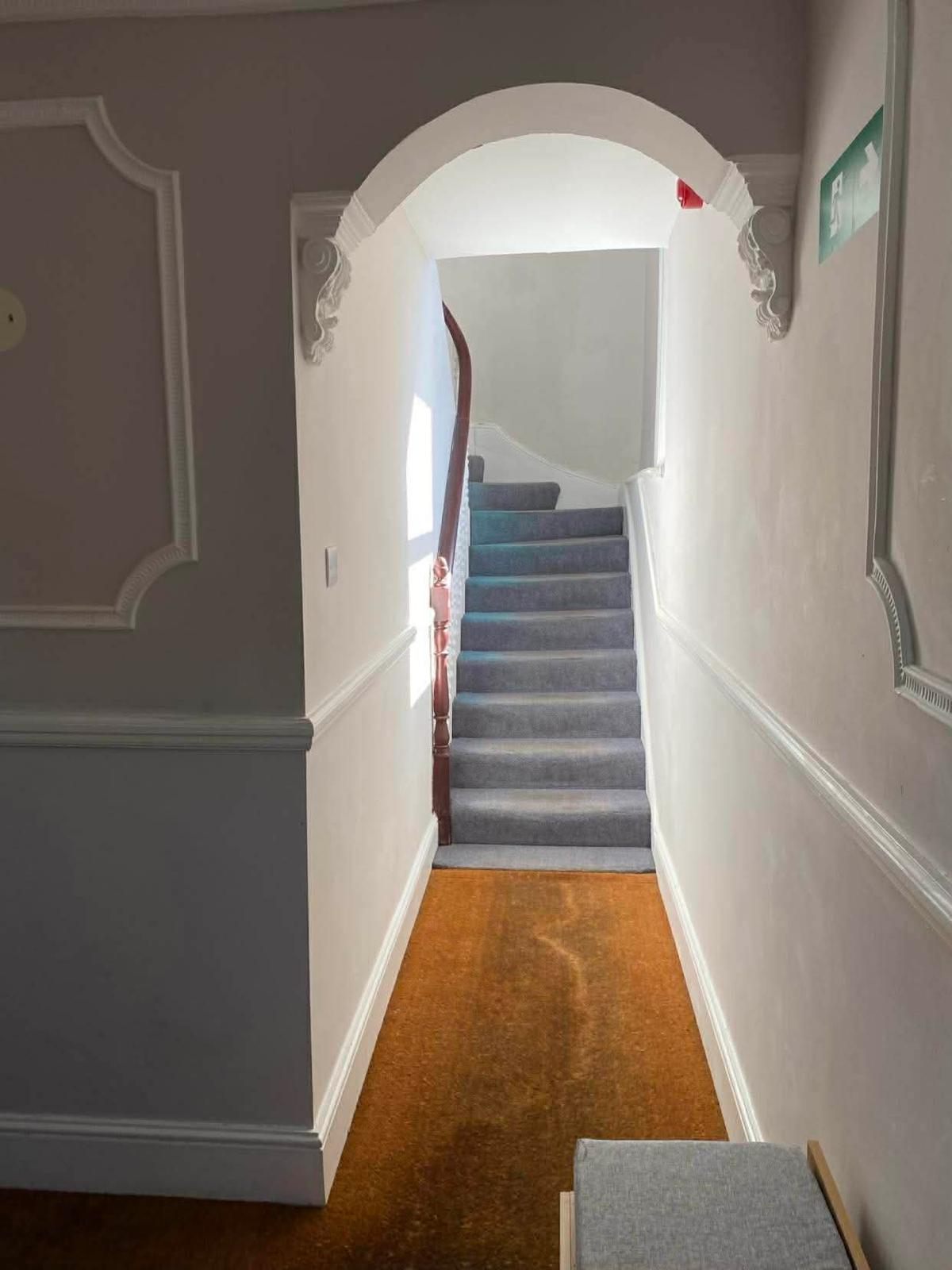 Arched hallway and carpeted stair in the first Wallington block