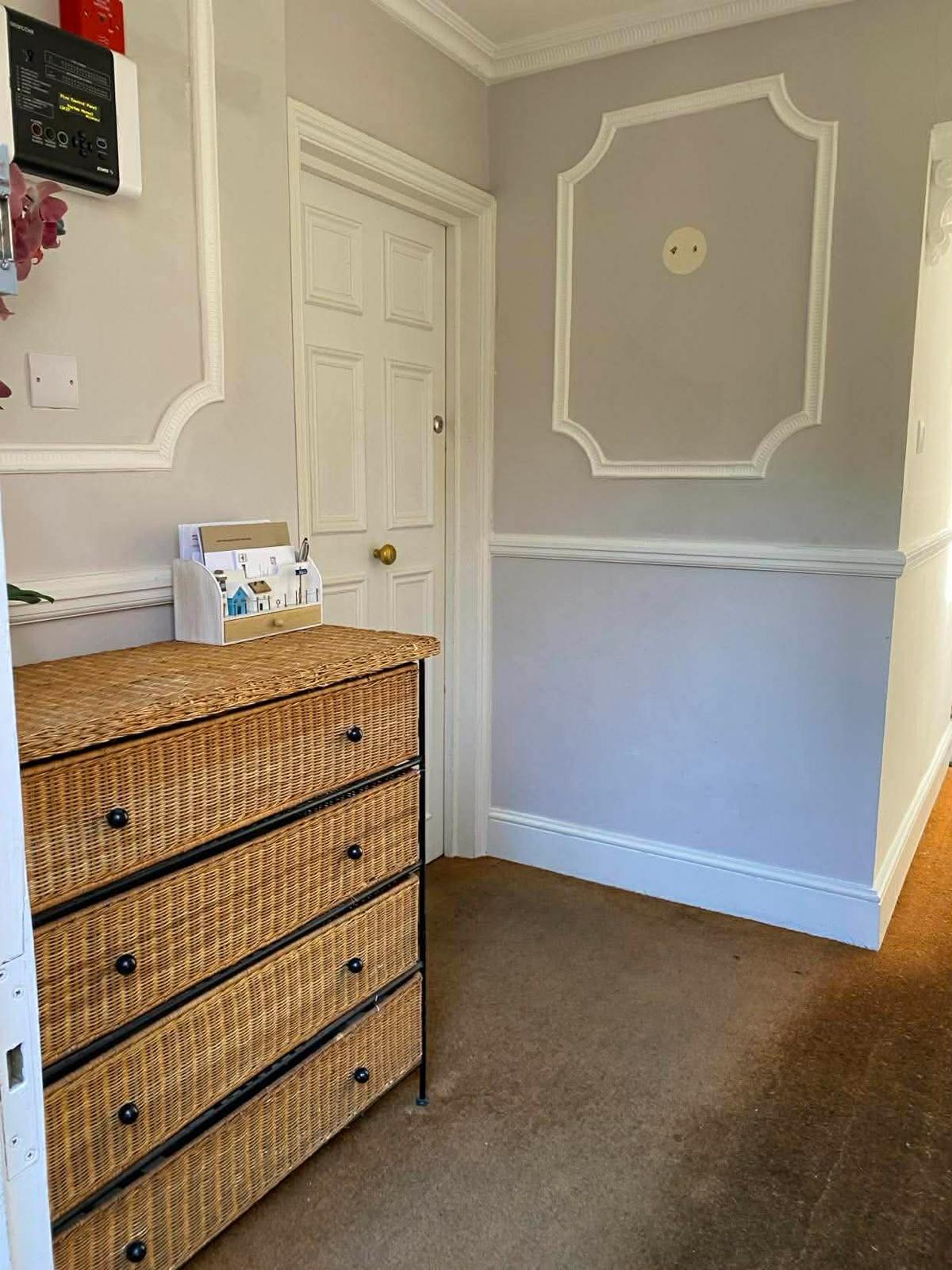 Moulded wall panels and post table in the first Wallington block's entrance hall