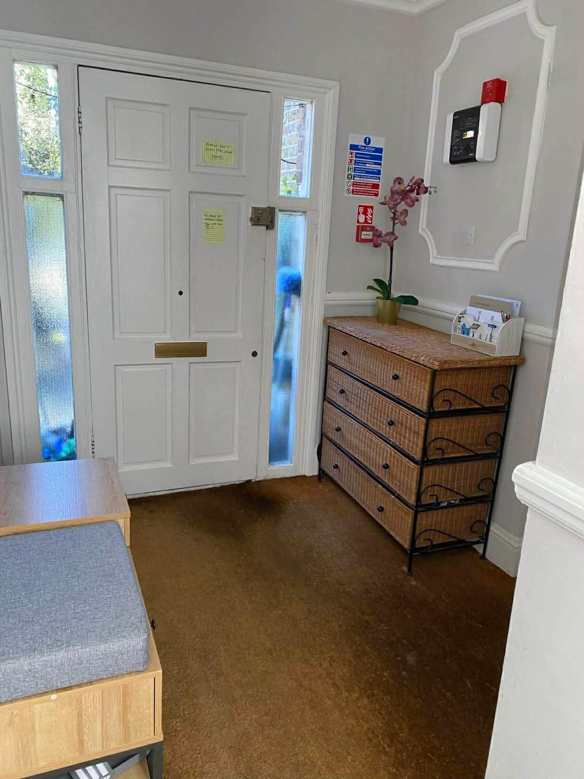 Entrance door, fire alarm panel and Fire Action notice in the first Wallington block
