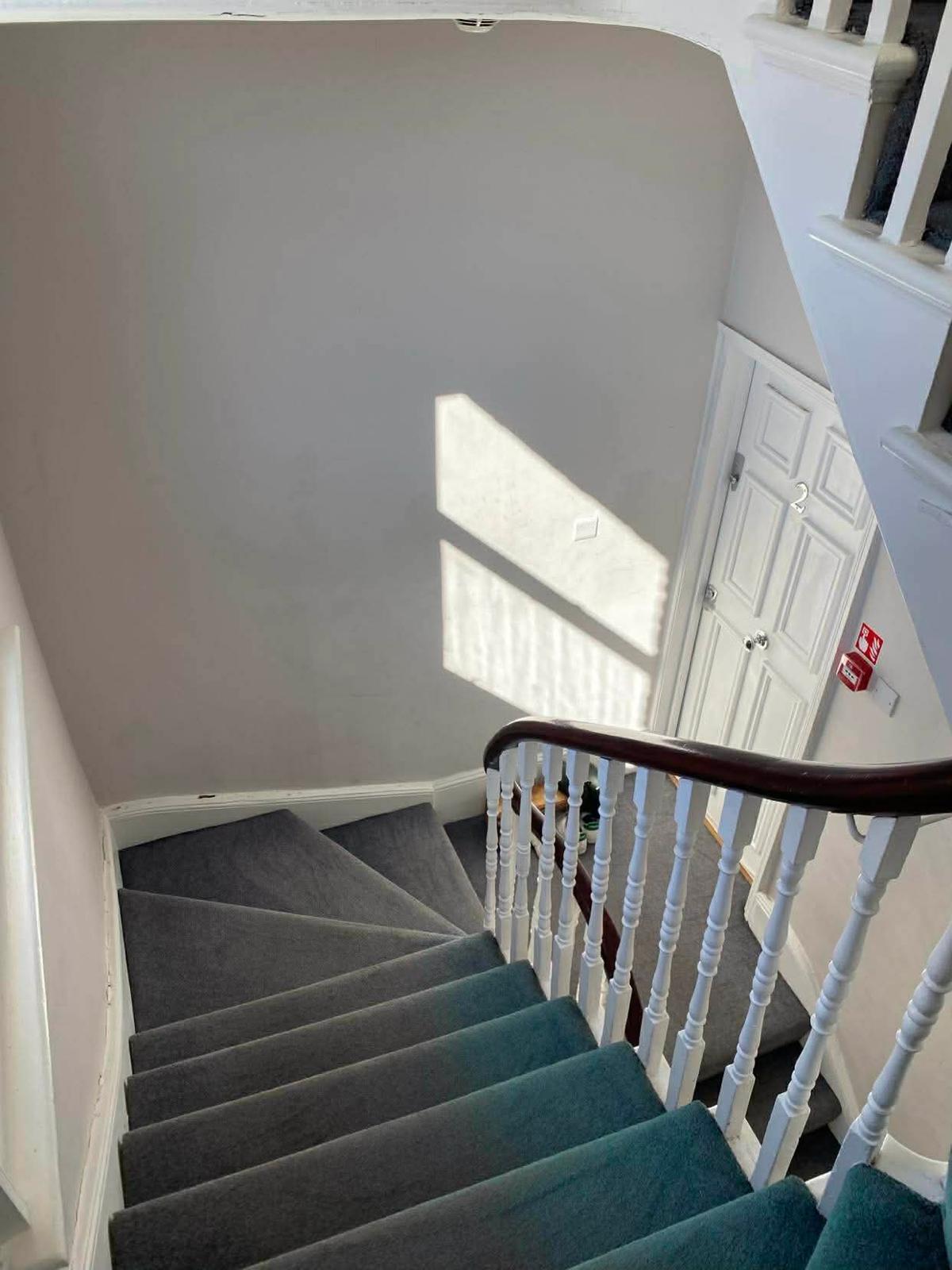 Looking down the stairwell of the first Wallington block towards a flat door